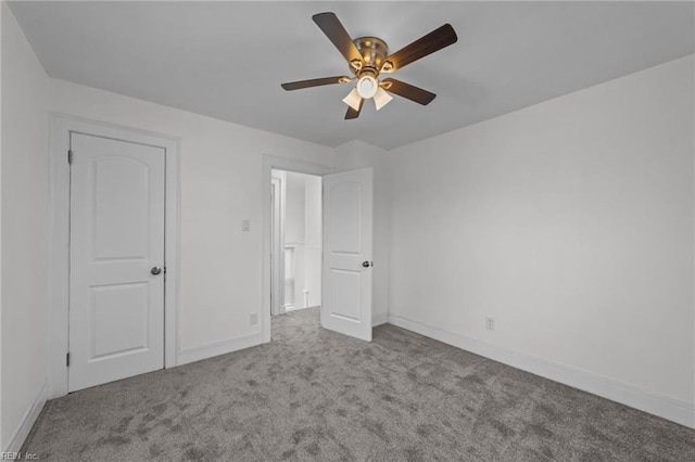 unfurnished bedroom featuring carpet, baseboards, and ceiling fan