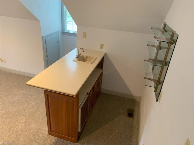 bathroom featuring lofted ceiling, baseboards, visible vents, and a sink