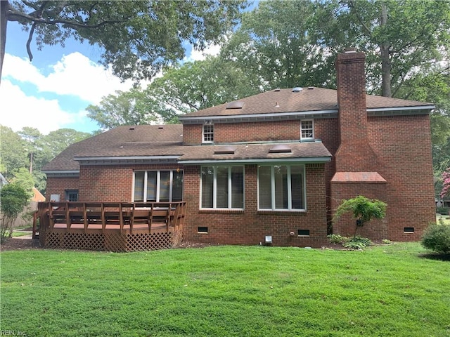 rear view of house with crawl space, a chimney, a yard, and a shingled roof