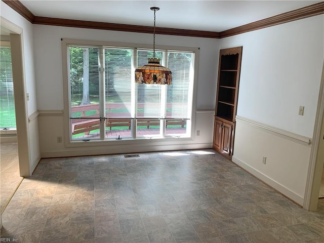 unfurnished dining area featuring crown molding, plenty of natural light, and visible vents