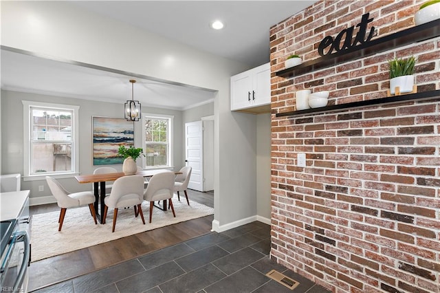 dining area featuring visible vents, baseboards, a chandelier, ornamental molding, and recessed lighting