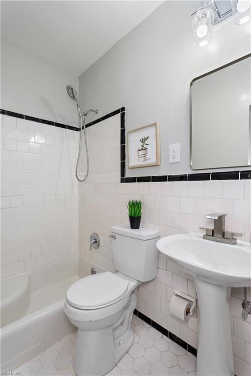 full bathroom with tile patterned flooring, toilet, tile walls, and walk in shower