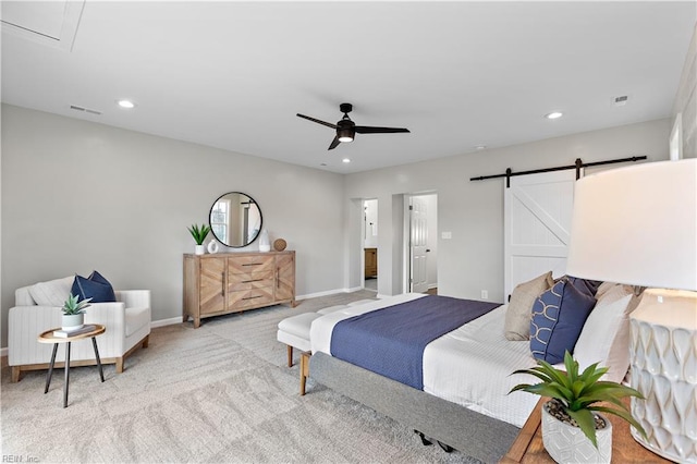 carpeted bedroom featuring recessed lighting, a barn door, baseboards, and visible vents