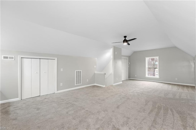 bonus room featuring visible vents, carpet flooring, lofted ceiling, and a ceiling fan