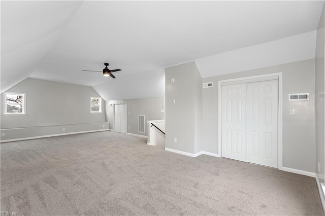 bonus room with visible vents, baseboards, carpet flooring, and vaulted ceiling