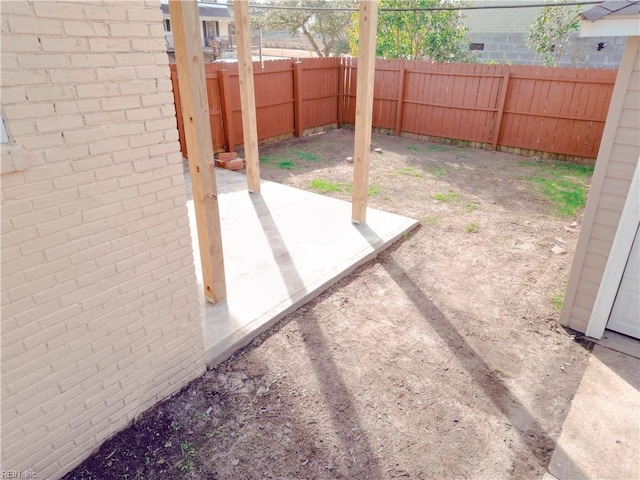 view of yard with a fenced backyard and a patio area