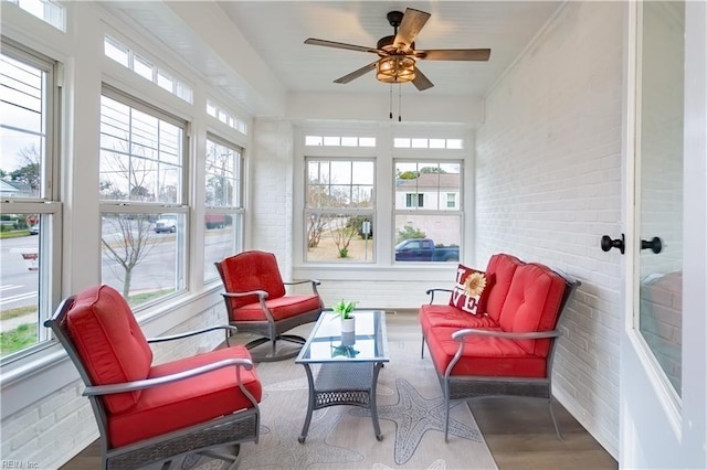 sunroom featuring a ceiling fan