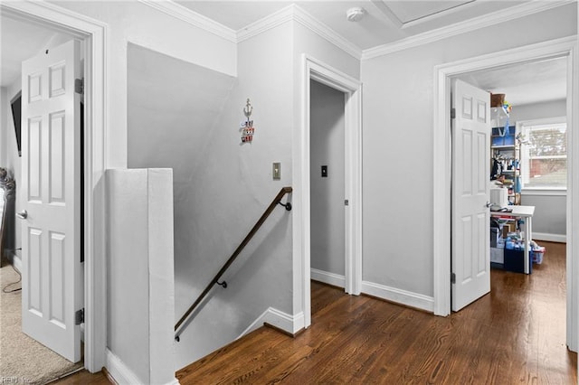 staircase with ornamental molding, baseboards, and wood finished floors