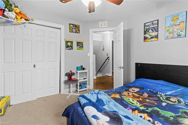 carpeted bedroom with a closet and ceiling fan