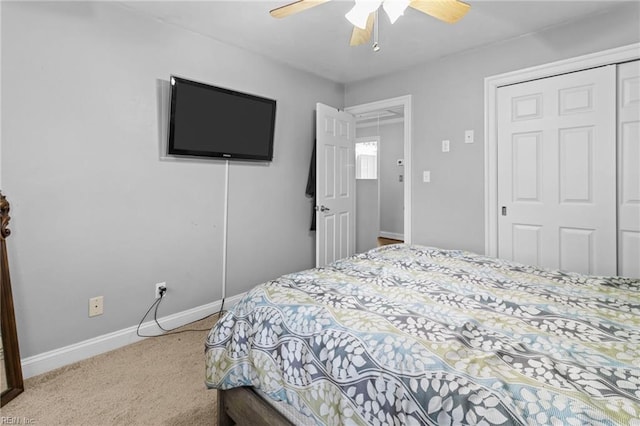 bedroom featuring a closet, baseboards, carpet, and a ceiling fan