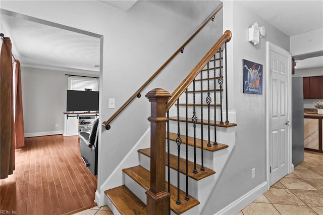 stairs featuring tile patterned flooring and baseboards