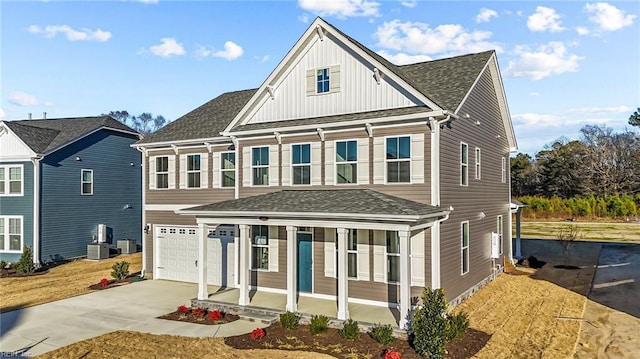 view of front of property with central air condition unit, driveway, board and batten siding, a shingled roof, and a garage