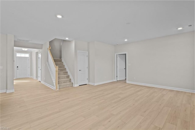 unfurnished living room featuring recessed lighting, stairway, light wood-style flooring, and visible vents