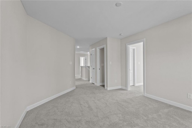 spare room featuring recessed lighting, baseboards, and carpet floors