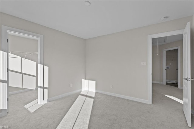 spare room featuring carpet flooring and baseboards