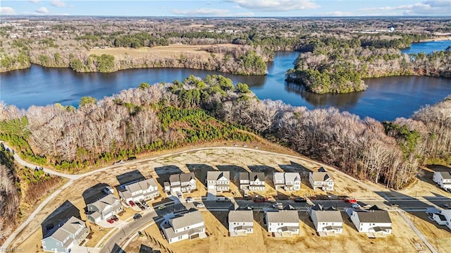 drone / aerial view featuring a residential view, a water view, and a wooded view