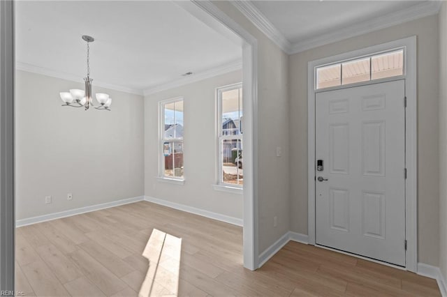 entryway featuring light wood-style floors, a chandelier, and crown molding