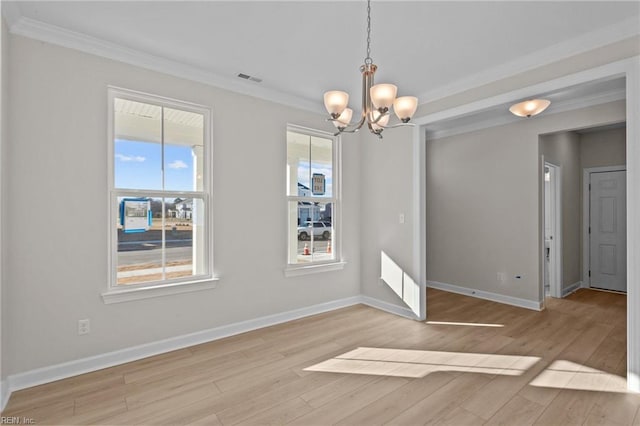 unfurnished dining area featuring a notable chandelier, light wood-style flooring, and crown molding