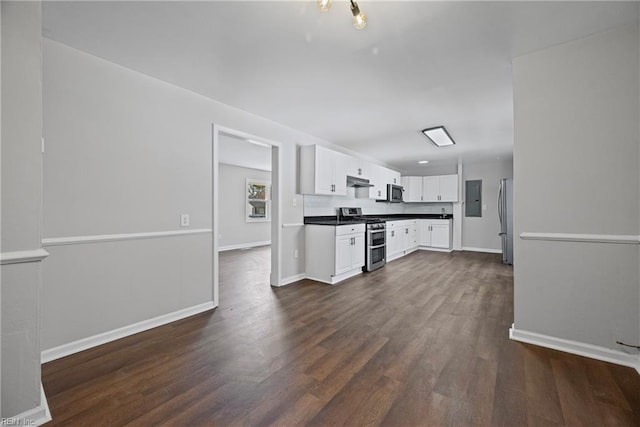 kitchen featuring dark wood finished floors, under cabinet range hood, electric panel, appliances with stainless steel finishes, and white cabinets