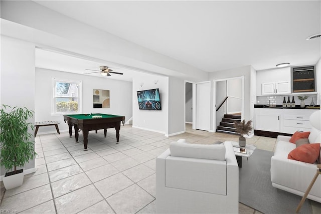 living room with pool table, bar area, stairs, and baseboards