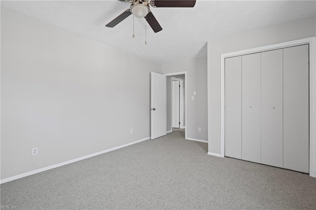 unfurnished bedroom featuring carpet flooring, a ceiling fan, baseboards, and a closet