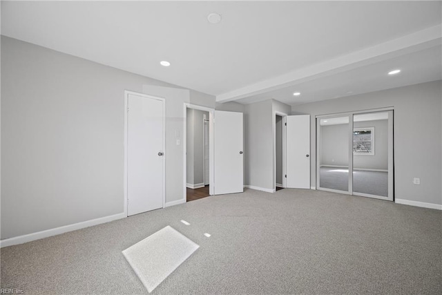 unfurnished bedroom featuring recessed lighting, baseboards, and carpet