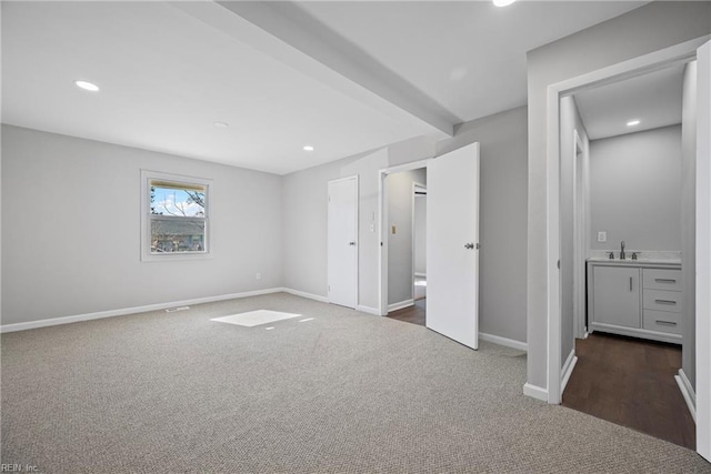 unfurnished bedroom featuring recessed lighting, beamed ceiling, baseboards, and carpet flooring