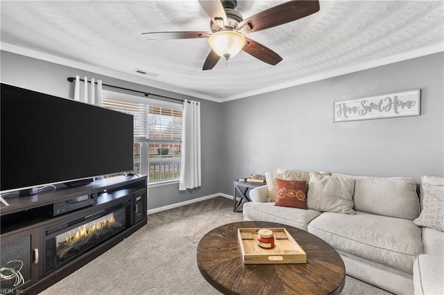 living room featuring baseboards, visible vents, ceiling fan, crown molding, and carpet flooring