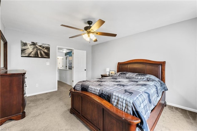 bedroom featuring light carpet, a ceiling fan, and baseboards