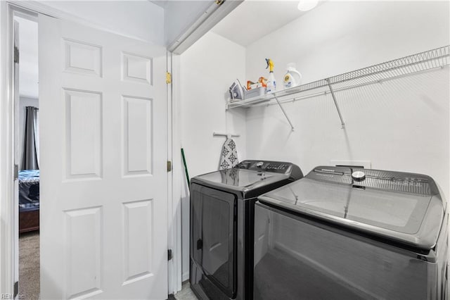 laundry room with laundry area and washer and clothes dryer