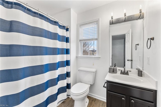 bathroom featuring vanity, wood finished floors, baseboards, curtained shower, and toilet