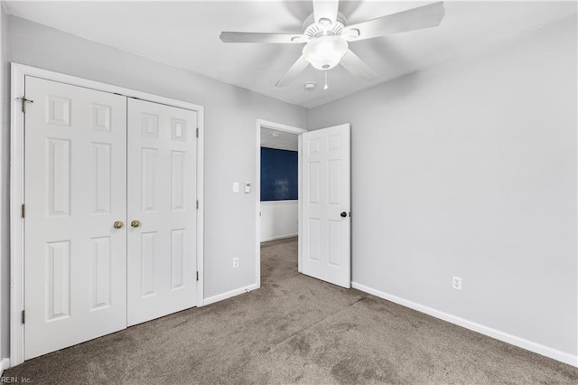 unfurnished bedroom with a ceiling fan, carpet, a closet, and baseboards