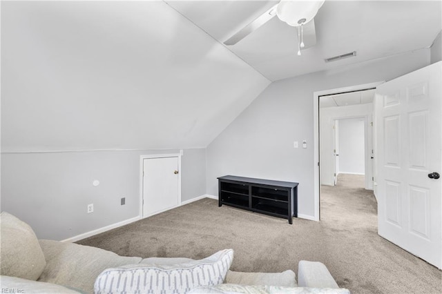 living room featuring vaulted ceiling, visible vents, carpet floors, and ceiling fan