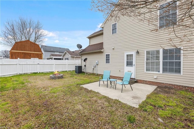 back of house featuring a patio area, a lawn, central AC unit, and fence