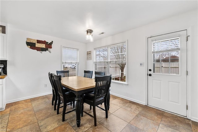 dining area with baseboards and visible vents