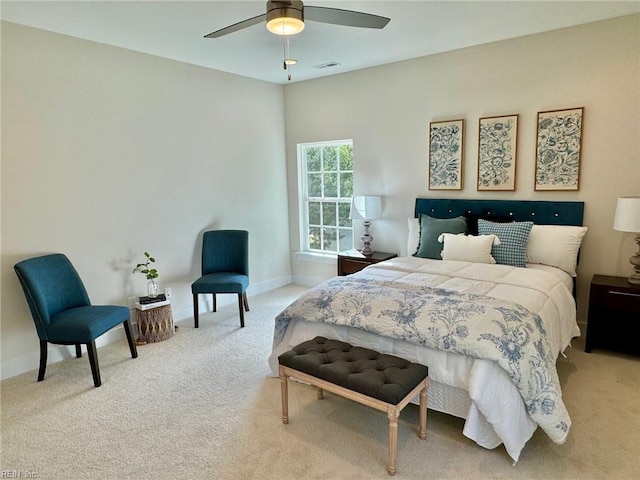 carpeted bedroom with visible vents, baseboards, and a ceiling fan