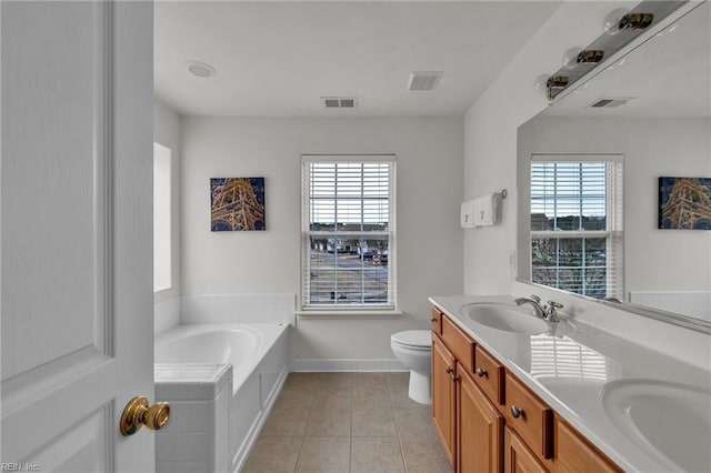 bathroom featuring tile patterned floors, visible vents, a healthy amount of sunlight, and a sink