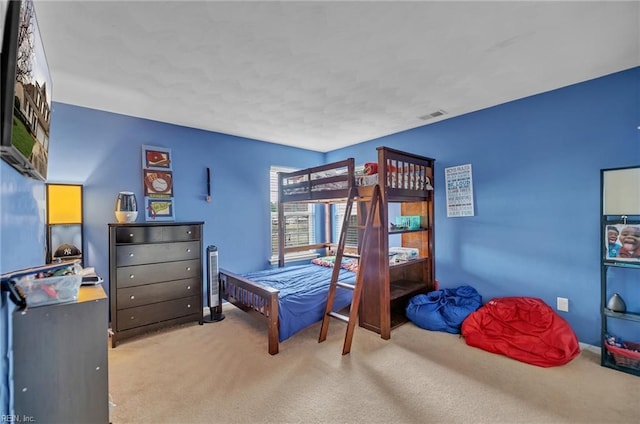 carpeted bedroom featuring visible vents