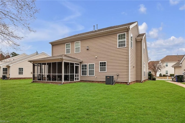 back of property with central AC unit, a lawn, and a sunroom