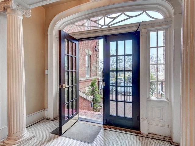 entryway featuring decorative columns and french doors