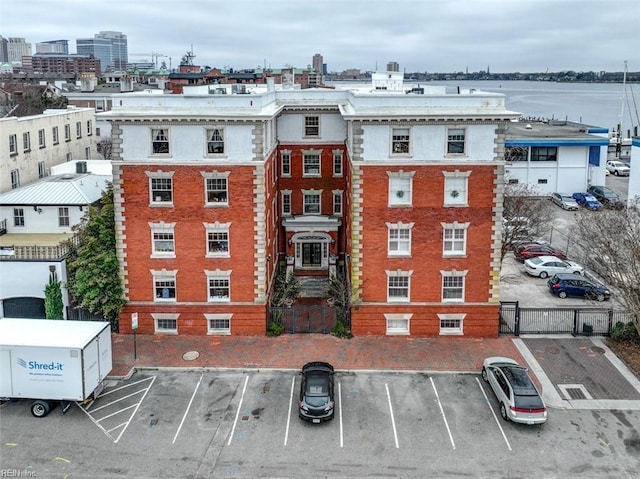 view of property featuring fence and uncovered parking