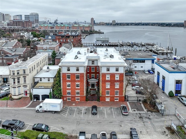 birds eye view of property featuring a view of city and a water view