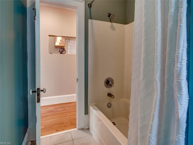 full bathroom with shower / bath combination with curtain and tile patterned flooring