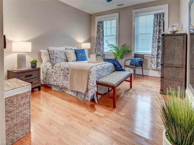 bedroom featuring visible vents, baseboards, and light wood-style flooring