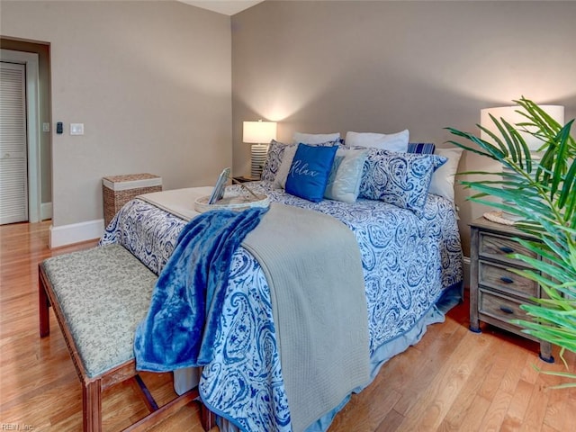 bedroom featuring baseboards and wood finished floors