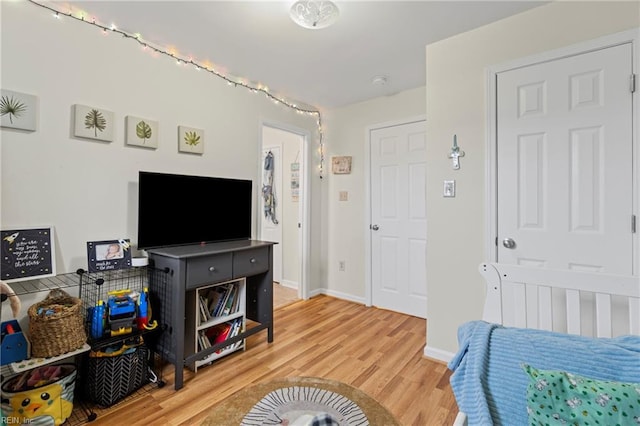 bedroom featuring light wood-style floors and baseboards