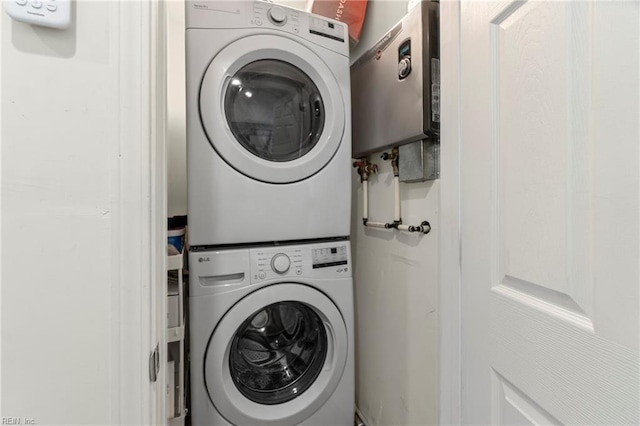clothes washing area with laundry area and stacked washer / drying machine