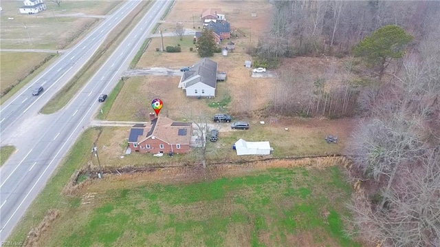 birds eye view of property with a rural view