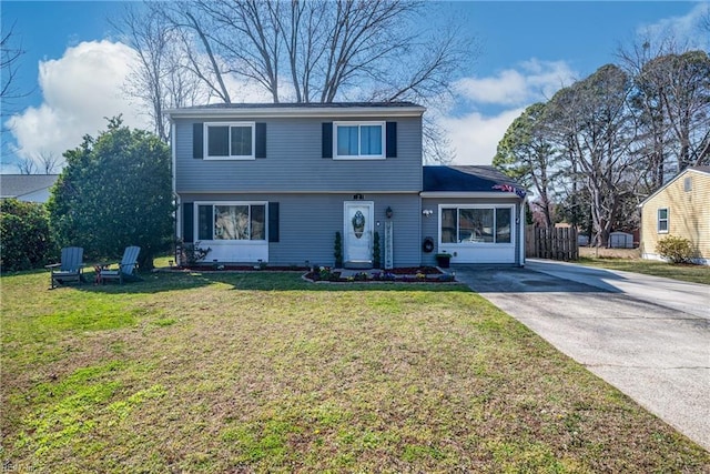 view of front of house featuring driveway and a front lawn