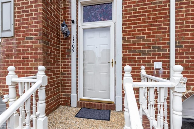 property entrance featuring brick siding